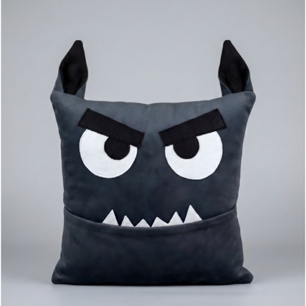 A square plush monster pillow designed as a cute werewolf for Halloween. It features pointy furry wolf ears on top, wide eyes, and white fangs protruding from its mouth. The mouth functions as a deep storage pocket.