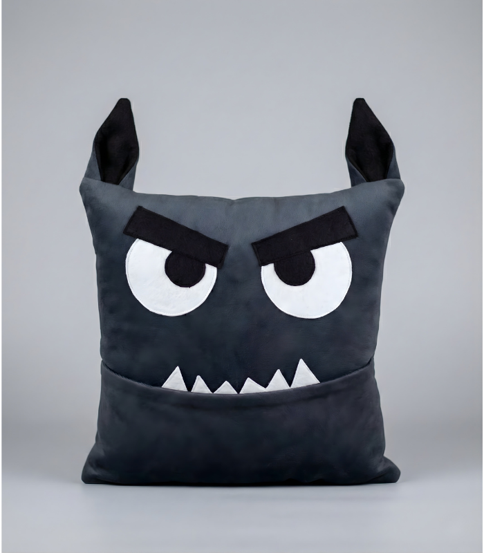 A square plush monster pillow designed as a cute werewolf for Halloween. It features pointy furry wolf ears on top, wide eyes, and white fangs protruding from its mouth. The mouth functions as a deep storage pocket.